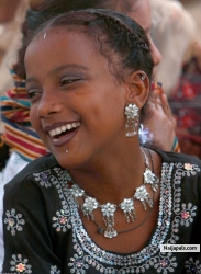 A Pakistani Sheedi girl smiles during a festival at Manghopir shrine in Karachi, Pakistan on Wednesday, June 17, 2009. The Sheedis are an ethnic group in Pakistan with dark features and curly hair whose ancestors are believed to have been brought to the subcontinent as slaves from Africa. Each year a ïCrocodile FestivalÍ is held at the 800-year-old shrine at Manghopir, an arid, hilly area at the outskirts of Karachi.