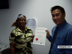 anne receiving her certificate of appointment in Singapore