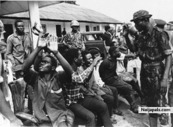 An Igbo soldier captured by Nigerian troops near Owerri in Biafra throws up his hands in anguish as his captors tell him he will die as a traitor, Sept. 1968.