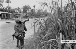 A federal Nigerian soldier holding an anti-tank bazooka is seen covering the end of the Aba-Umuahia road where Biafran troops hold positions, Sept. 21, 1968.
