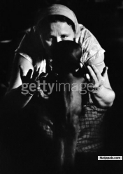 A white carer with a Biafran child holding onto her fingers during the civil war in Biafra (now part of Nigeria), 1969