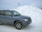 My car dwarfed by snow pile