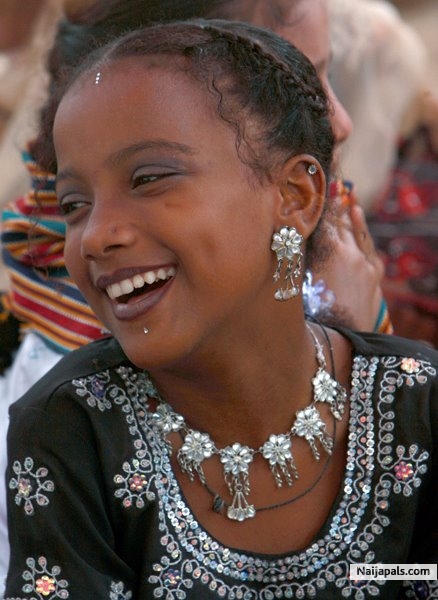 A Pakistani Sheedi girl smiles during a festival at Manghopir shrine in Karachi, Pakistan on Wednesday, June 17, 2009. The Sheedis are an ethnic group in Pakistan with dark features and curly hair whose ancestors are believed to have been brought to the subcontinent as slaves from Africa. Each year a ïCrocodile FestivalÍ is held at the 800-year-old shrine at Manghopir, an arid, hilly area at the outskirts of Karachi. - click for next photo
