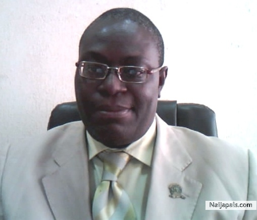 Olufemi Adelusi behind the desk - click for next photo