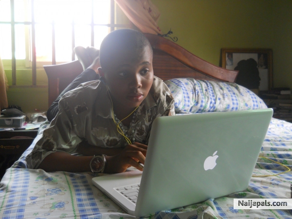 Isaiah Browsing with is apple mac book - click for next photo