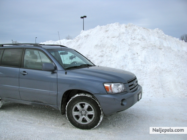 My car dwarfed by snow pile - click for next photo