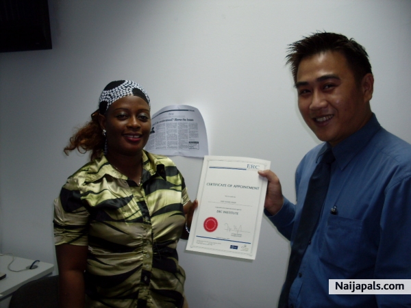 anne receiving her certificate of appointment in Singapore - click for next photo