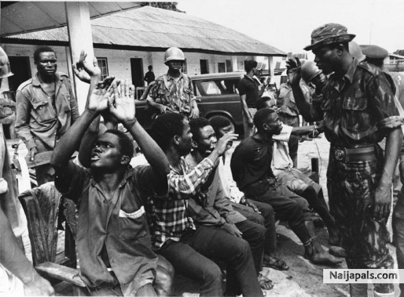 An Igbo soldier captured by Nigerian troops near Owerri in Biafra throws up his hands in anguish as his captors tell him he will die as a traitor, Sept. 1968. - click for next photo