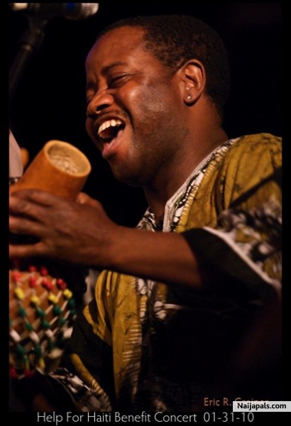Baba plays sekere - click for next photo