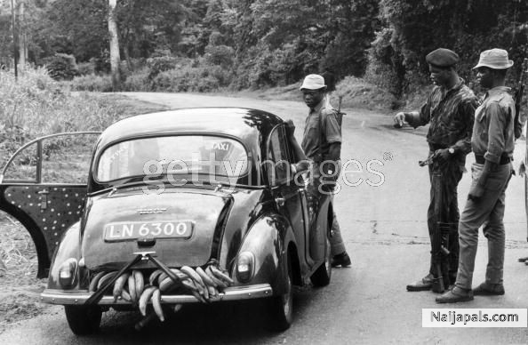 1968 Federal troops halt a car laden with food on the road to Onitsha, Nigeria, during the Biafran War. They are stopping all traffic on the road - click for next photo