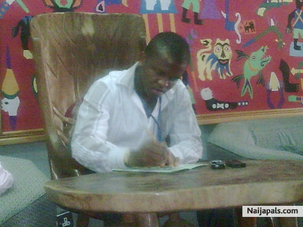 bizzy writing in ECOWAS SECRETARIAT, AMCOST III MEETING - click for next photo