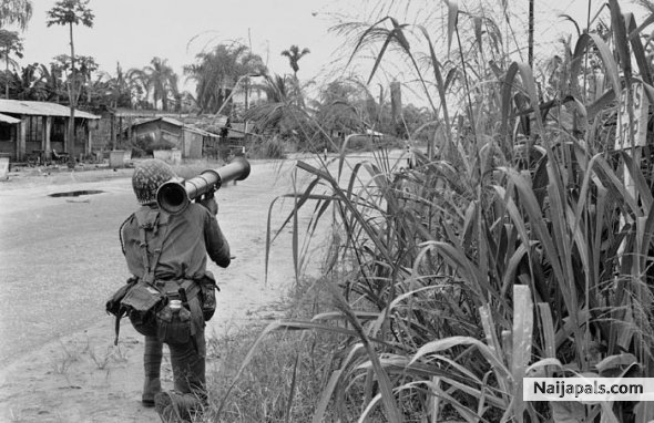A federal Nigerian soldier holding an anti-tank bazooka is seen covering the end of the Aba-Umuahia road where Biafran troops hold positions, Sept. 21, 1968. - click for next photo