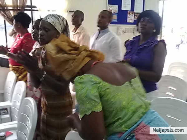 A sister praising God for the live worship at Glorious Word ministries - click for next photo