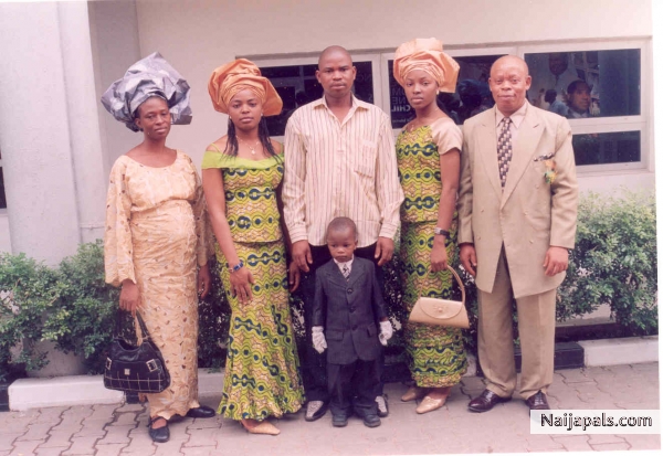 Dr. Phil dressed in gold at a wedding party(posing with family friends) - click for next photo
