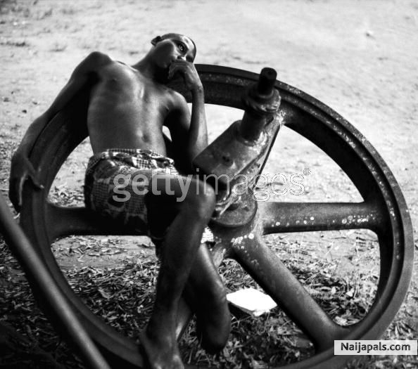An amputee resting on a large wheel during the civil war in Biafra (now part of Nigeria), 1969 - click for next photo